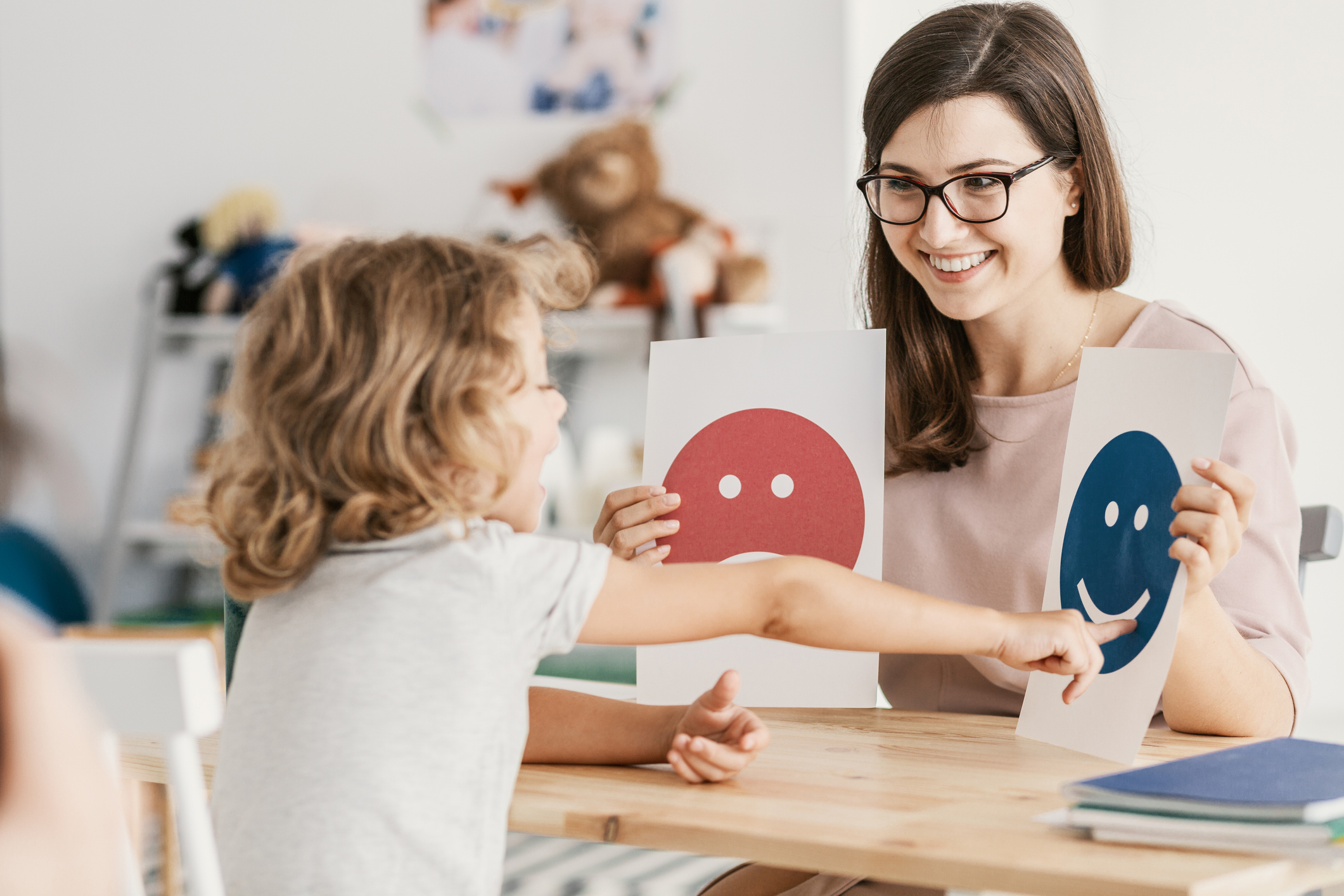 Child learning to identify emotions with support from a teacher at Prescolaire Early Learning Academy 